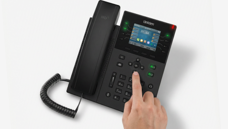 Hand pressing a Uniden desk phone — quick setup